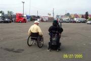 Two determined men in deep conversation, Scott Remington and Sam, head toward the pit area at Watkins Glen, New York's Thunder Road.